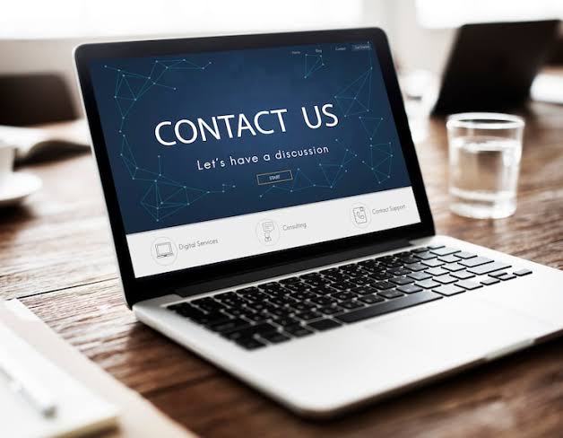 Laptop on a desk showing a Contact Us page